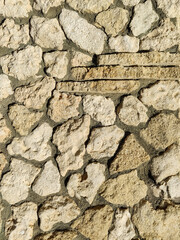 Masonry wall of old stone blocks of limestone. Background texture of wild calcareous stone,...