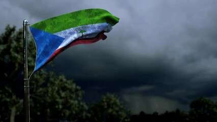 waving Equatorial Guinea flag for anthem day on dark storm cumulus