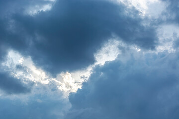 gray clouds in the blue sky of a summer sunny day