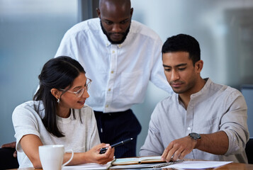 Employees, business meeting and table with book in office for teamwork, communication and planning....