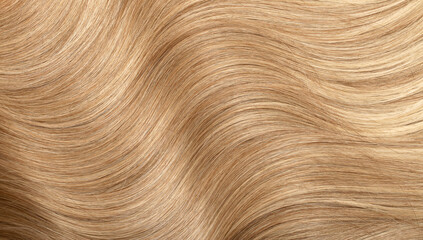 Blond hair close-up as a background. Women's long blonde hair. Beautifully styled wavy shiny curls....