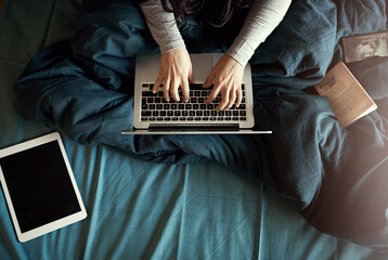 Laptop, tablet and woman hands typing on bed for research on creative project with book report...