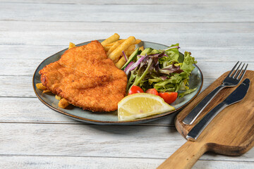 Chicken Schnitzel is a popular dish consisting of thinly pounded chicken breast coated in breadcrumbs and then fried until crispy and golden brown.