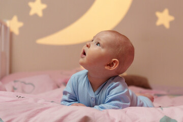 Dream Baby Nestled Among Moon and Stars in Bed, going to sleep.