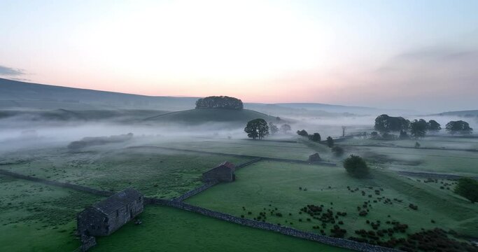 Flying over English countryside on a misty morning