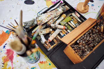 Paint brush, art supplies and tools for creativity in studio, color and craft in small business and above. Workshop, equipment and jars or container for project, decoration and painting in store