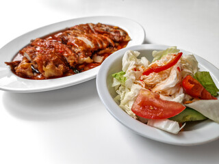 Chicken baked with onion in tomatoes with white cabbage salad.