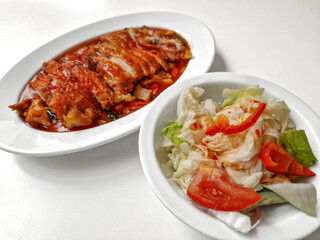Chicken baked with onion in tomatoes with white cabbage salad.