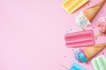 Assorted colorful pastel summer ice cream cones and popsicle frozen desserts. Top down view side...