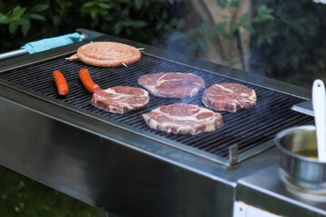 Steak and sausages grilling on BBQ