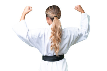 Young Uruguayan woman over isolated background doing karate in back position © luismolinero