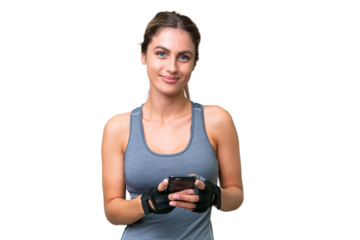 pretty Sport Uruguayan woman over isolated background sending a message with the mobile