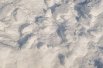 Uneven fluffy snow. Snowy background for publication, poster, calendar, post, screensaver,...