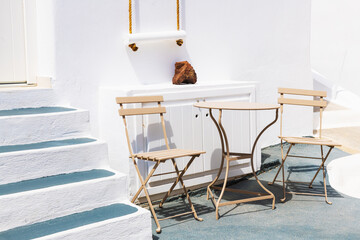 White architecture in Santorini island, Greece. Two chairs with table on the terrace