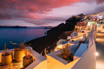 Night lights at sunset in Santorini island, Greece. White architecture with sea view in Fira town.
