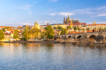 Charles bridge (Karlův most) and Hradcany castle hill over Vltava in golden hour,, Prague, Czech Republic