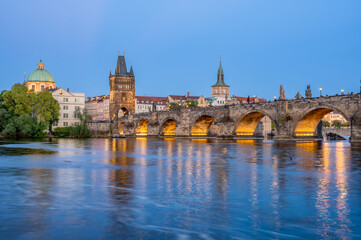 Charles Bridge (Karlův most) over Vltava river, illuminated in the evening, Prague, Czech Republic