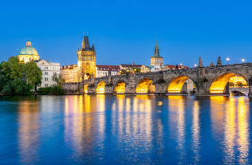 Charles Bridge (Karlův most) over Vltava river, illuminated in the evening, Prague, Czech Republic