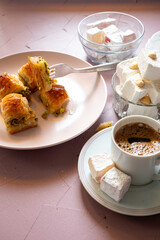 baklavas, Turkish coffee and Turkish delights on pink background