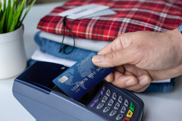 man hand hold plastic card and pay pass online terminal