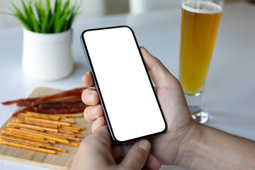 male hand hold phone isolated screen background beer in cafe.