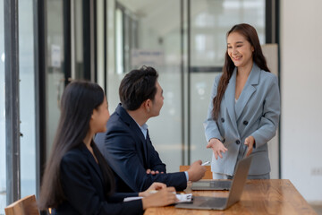 Young professionals having a discussion in a modern office setting. Business meeting, teamwork, collaboration, and corporate environment.