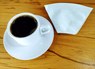 Cup of coffee and paper v60  coffee filter on the wooden background