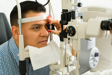 Focused ophthalmologist conducts a thorough eye examination using specialized tools