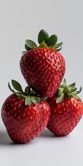 Three Strawberries Stacked on Top of Each Other