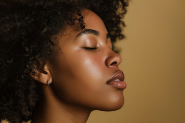 Fototapeta premium A close up of a black woman's face with her eyes closed looking to a side
