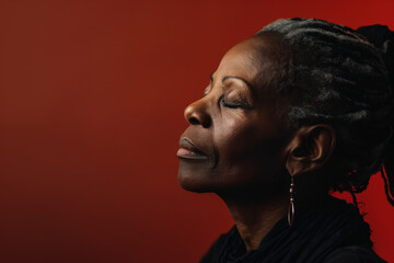 A close up of a black woman's face with her eyes closed looking to a side
