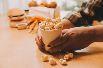 A woman holding a bowl of popcorn