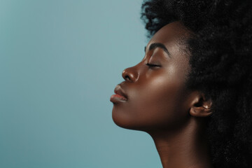 A close up of a black woman's face with her eyes closed looking to a side