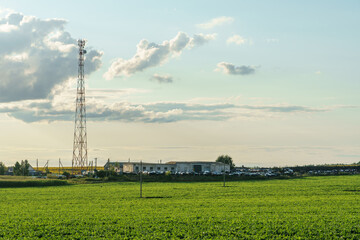 New GSM antennas on a high tower against a blue sky background. 5G signal transmissions are dangerous to health. Radiation pollution of the environment through cell towers. Harm to health