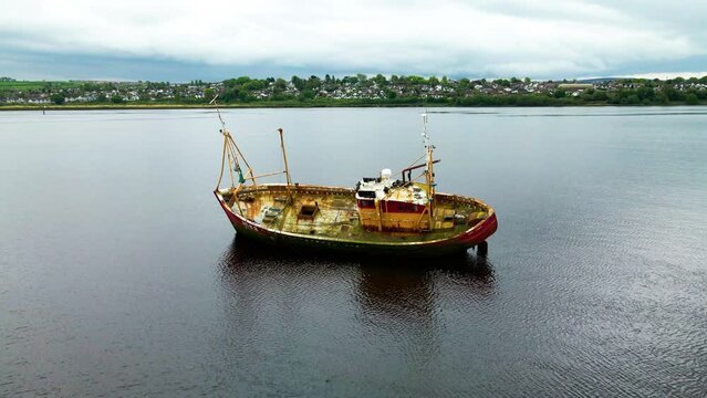 A drone shot moving towards a shipwreck in the Foyle River, Derry, Northern Ireland