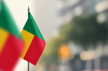 Small flags of Benin on a blurred background