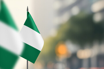Small flags of Nigeria on a blurred background