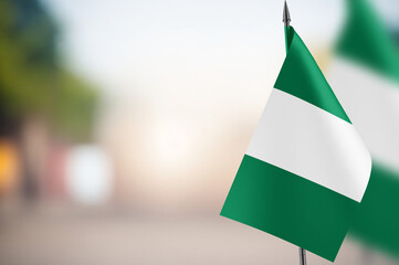 Small flags of Nigeria on a blurred background