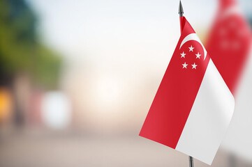 Small flags of Singapore on a blurred background