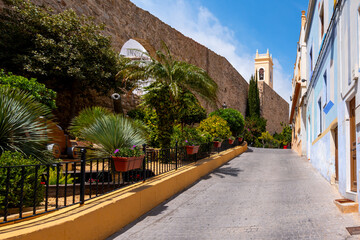 Historic old town of Calpe with church tower and picturesque street, Costa Blanca, Spain