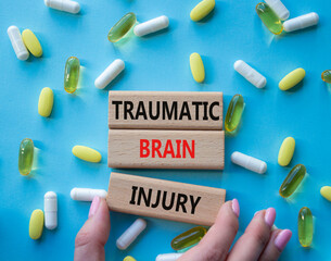 Traumatic Brain Injury symbol. Concept words Traumatic Brain Injury on wooden blocks. Beautiful...