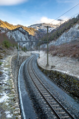 Fototapeta premium Rhaetian Railway line through the Grisons Alps in Switzerland, Rhine Canyon, in winter.