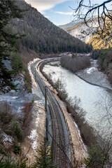 Rhaetian Railway line through the Grisons Alps in Switzerland, Rhine Canyon, in winter.