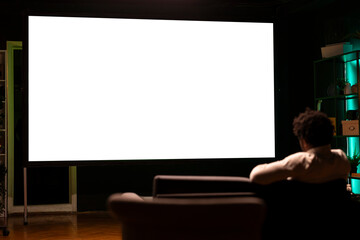 Person using isolated screen ultrawide smart TV to binge series on subscription based streaming services. African american man relaxing, enjoying video on demand shows on mockup television display