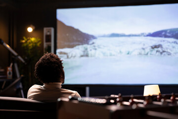 Cord cutter mesmerized by online nature clips with beautiful cinematography on widescreen smart TV...