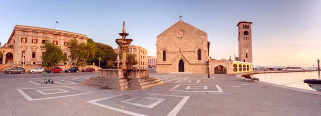 Panorama of Evangelismos Church and historic fountain in Rhodes, Greece, in the morning