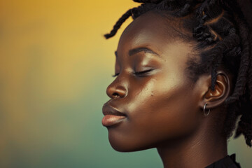 A close up of a black woman's face with her eyes closed looking to a side