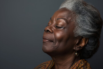 A close up of a black woman's face with her eyes closed looking to a side