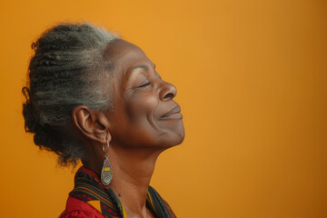 Fototapeta premium A close up of a black woman's face with her eyes closed looking to a side