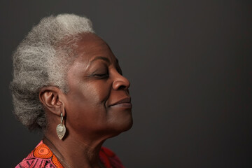 Fototapeta premium A close up of a black woman's face with her eyes closed looking to a side